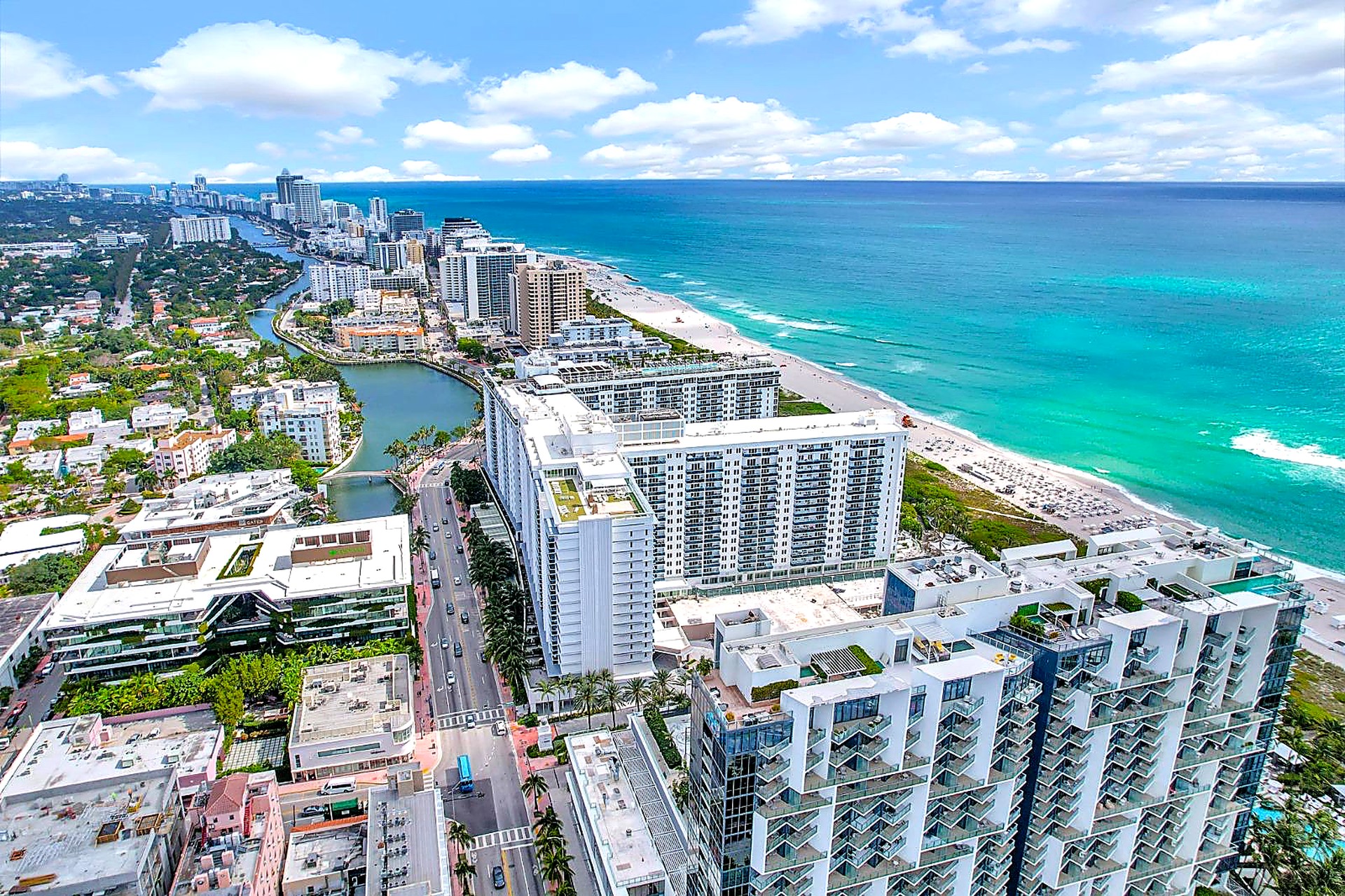 Aerial view of the Roney Palace oceanfront condo towers, pools and beach at 2301 Collins Ave, Miami Beach
